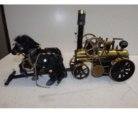 A Wilesco D430 "lokomobile" live steam traction engine fitted with two horses pulling. Full length 21"  Condition report: It 