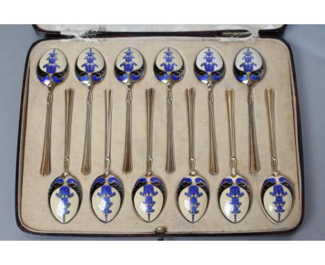 A MATCHED SET OF TWELVE SILVER GILT AND ENAMEL COFFEE SPOONS, maker Turner &amp; Sons, Birmingham 1936 (x2) and 1937, with fl