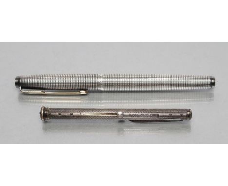 A STERLING SILVER COMBINATION PEN/KNIFE, maker Sampson Mordan &amp; Co., the cylindrical case with wavy engine turning enclos