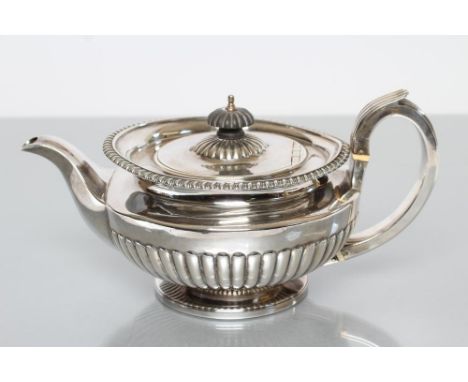 A GEORGE IV SILVER TEAPOT, maker William Bateman, London 1820, of compressed semi fluted globular form with everted gadrooned