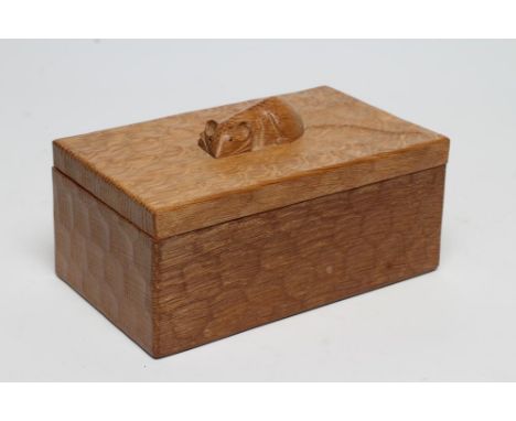 A ROBERT THOMPSON ADZED OAK TRINKET BOX of oblong form, the lift-off lid with carved mouse trademark in high relief, 7 1/4" w