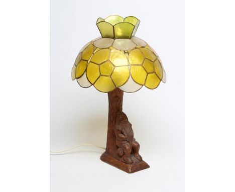 A TOM WHITTAKER OAK TABLE LAMP, (Littlebeck - Gnome Man), carved as a gnome resting under a tree, 8 1/2" x 15" to top of ligh