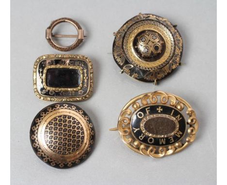 A COLLECTION OF VICTORIAN MOURNING JEWELLERY comprising two pique work tortoiseshell boss brooches, two black enamel "In Memo