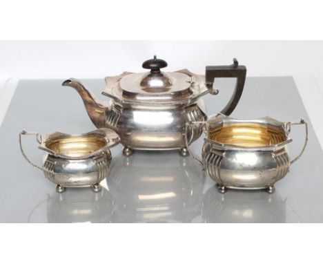 A SILVER THREE PIECE TEA SERVICE, maker Martin, Hall &amp; Co., Birmingham 1922, of canted oblong baluster form with reeded a