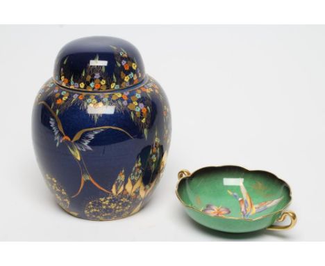 A CARLTONWARE GINGER JAR AND COVER, 1920's, painted in typical jewelled enamels and gilt with the Phoenix pattern on a dark b