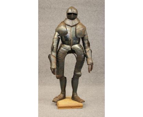 A SUIT OF 17TH CENTURY STYLE CUIRASSIER ARMOUR, the helmet with mild comb, open eyelets, large brow peak and two piece visor,