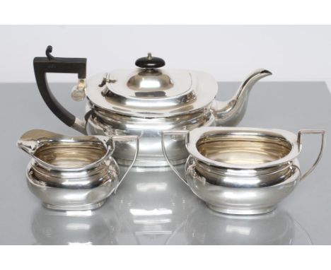 A SILVER THREE PIECE TEA SERVICE, maker Jones &amp; Crompton, Birmingham 1912, of plain rounded oblong baluster form, compris