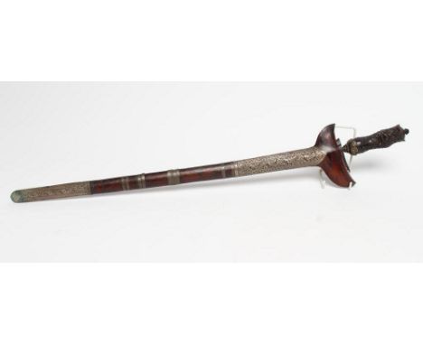 A LARGE MALAY KRIS, early 20th century, with 23 1/2" damascus blade, foliate carved grip and typical scabbard applied with fo