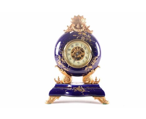 A French gilt spelter and porcelain mantel clock, late 19th century, with gilt foliate decoration on a dark blue ground, 39.5