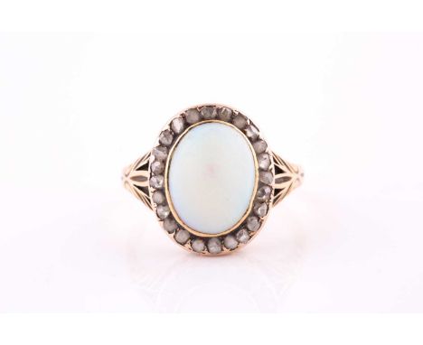 A late Victorian opal and diamond cluster ring; the oval opal within a border of rose cut diamond ; to carved and engraved ta