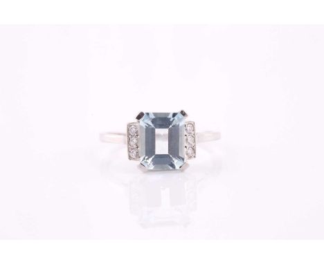 An aquamarine and diamond ring, the 9 x 7mm rectangular step cut aquamarine with three diamonds to each shoulder, estimated t