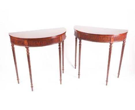 A pair of George III style figure mahogany demi lune console tables, 20th century, with crossbanded top, on turned tapering f
