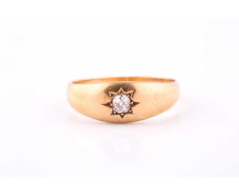 A diamond single-stone ringThe 18ct yellow gold band gypsy-set with an old brilliant-cut diamond, approximately 0.15ct, stamp