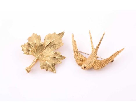 A gold brooch by Garrard & Co. and a gold broochOne with engraved detail of a swallow, the second depicting a maple leaf, bot