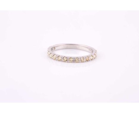 A yellow diamond half eternity ring, the eighteen uniform size round brilliant cut diamonds, averaging 2mm diameter, claw set