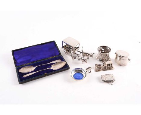 A mixed group of small silver items, to include a cased pair of spoons, an enamel-lined ashtray, a vesta, two models of a coa