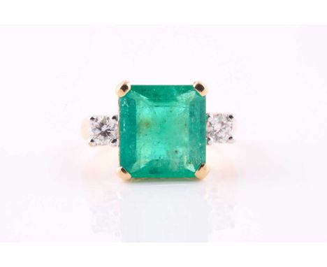 An emerald and diamond ring, the square step cut emerald measuring 11.5 x 10mm approximately, with a round brilliant cut diam
