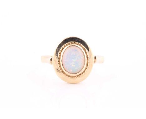 A synthetic opal single-stone ringThe oval cabochon opal in collet setting within a ropetwist border, to a polished mount, st