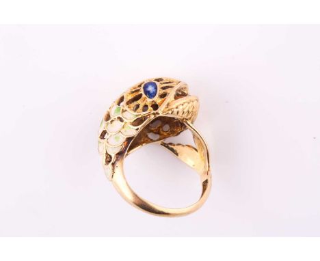 An enamel novelty ring, designed as a coiled fish with polychromed enamel body, to yellow precious metal mount, ring size N, 
