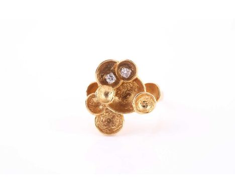 A 1970s diamond-set gold foliate ringThe 18ct yellow gold textured petals highlighted by two brilliant-cut diamonds, approxim