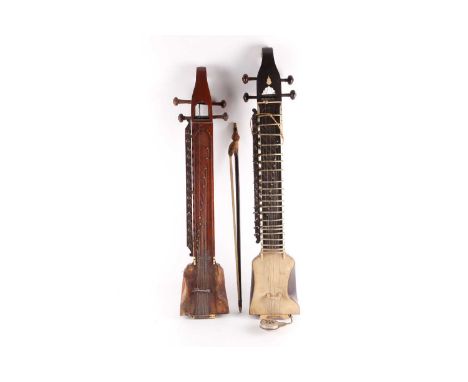 Two Indian Dilruba, 20th century, each with animal hide resonator, and turned tuning pegs, the finger boards terminating in r