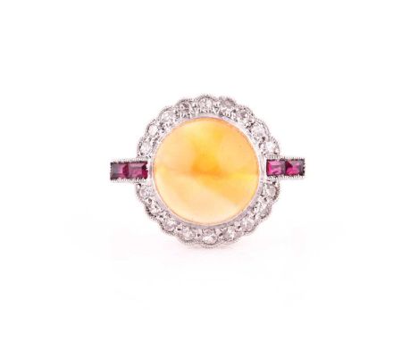 An Art Deco opal, ruby and diamond ring,of bi-coloured design, the sugarloaf orange opal within a scalloped surround of brill