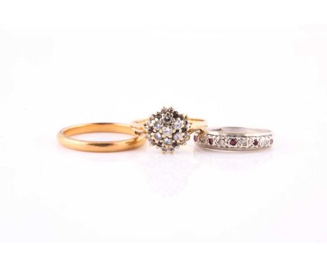 A ruby and diamond ring, a diamond cluster ring and a wedding band1st) set to the front with alternating inset circular-cut r