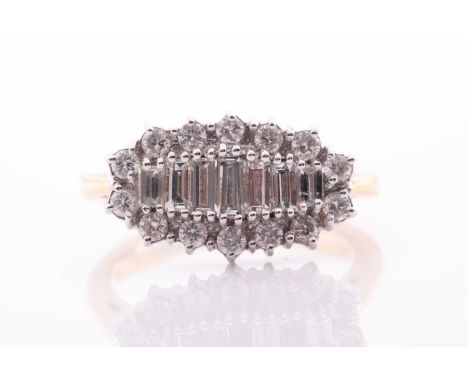 An 18ct yellow gold and diamond ring, set with a graduated row of graduated baguette-cut diamonds within a border of round br