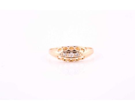 An early 20th century 18 carat gold three stone gold hoop diamond ring; the graduated mixed old cut diamond in rub-over and c