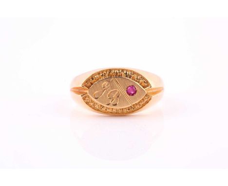 A ruby-set signet ringThe lozenge-shaped plaque engraved JB, inset with a circular-cut ruby within a textured border to a pol