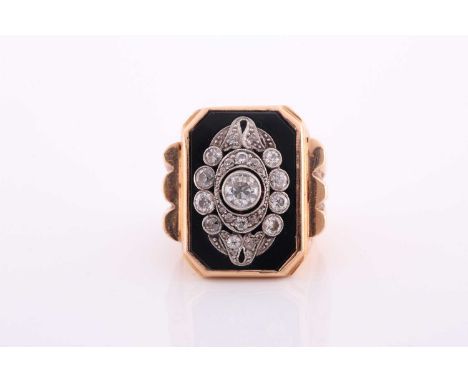 A yellow metal and diamond ring, the chamfered rectangular black onyx plaque, inset with old-cut diamonds, the central diamon