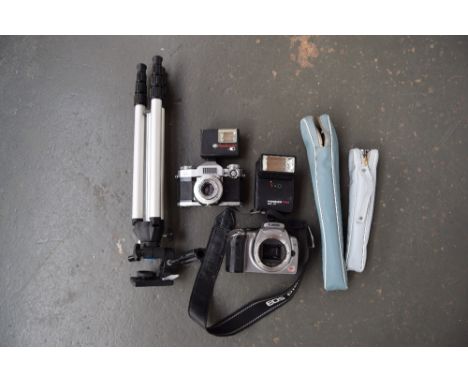 A Zeiss Ikon Contaflex Synchro-Compur  35mm camera, a Canon EOS body, two flash units, a Miranda tripod. a Velbon tripod in c