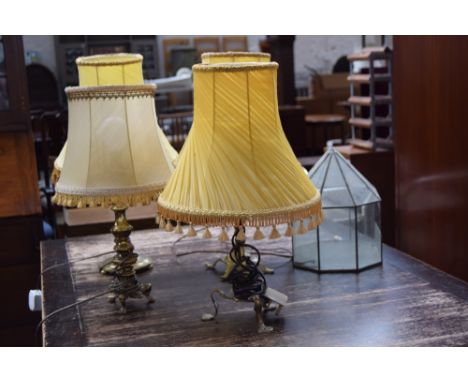 Four brass based table lamps with yellow shades and a stained glass lantern by Chris Franken