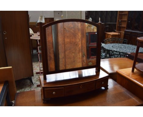 An early 19th Century mahogany toilet mirror, the rectangular plate raised on reeded tapering supports fitted turned ivory fi