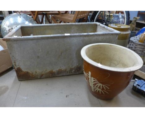A galvanised tank and a ceramic garden pot 