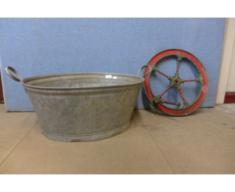 A small galvanised tub and a cast iron traction engine cog 