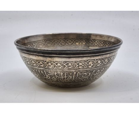 An Egyptian white metal bowl, the side and base engraved to both interior and exterior with calligraphy panels (white metal a