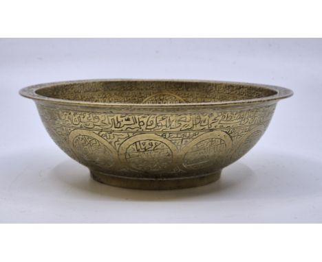 A 19th century Islamic brass "Magic" bowl, with raised central boss to well and allover engraved calligraphy, diameter 16.1cm