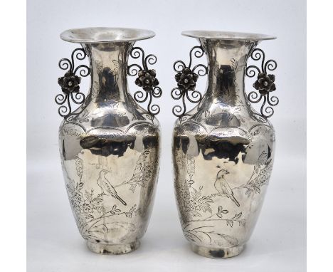 A pair of Chinese export silver twin handled vases, of baluster form with out swept rim, having wire work handles with applie