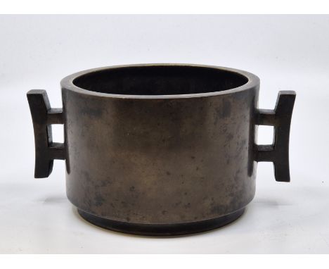 A Chinese bronze twin-handled censor, 18th/19th century, base with relief cast character marks, diameter exc. handles 14.2cm.