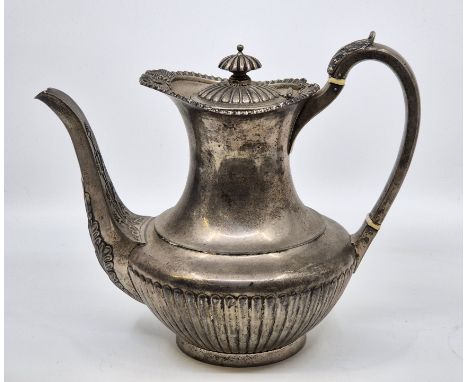 A silver coffee pot, by R & S Garrard & Co, London 1911, of semi-fluted baluster form, having scroll handle with acanthus lea