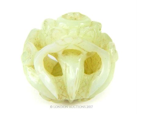 A 19th century Chinese carved jade carved concentric ball in the form of a fire breathing dragon, 5 cm diameter.