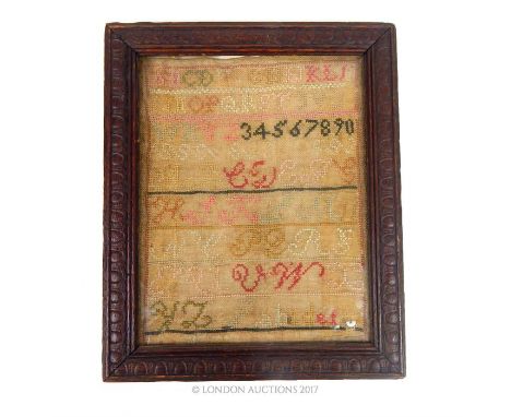 A vintage textile with alphabet and numbers; sight size 24.5cm x 19cm; with rustic frame.