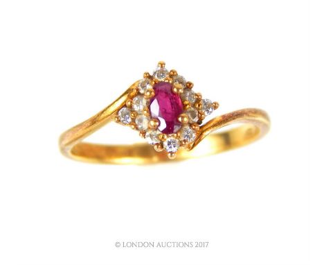 An 18 ct yellow gold diamond and ruby cluster ring, centrally set with a claw-set marquise-shaped ruby and surrounded by a ha