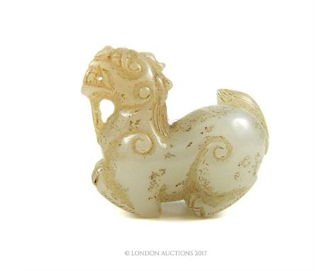 A Chinese carved jade figure in the form of a dragon, 4 x 4.5 x 2cm.