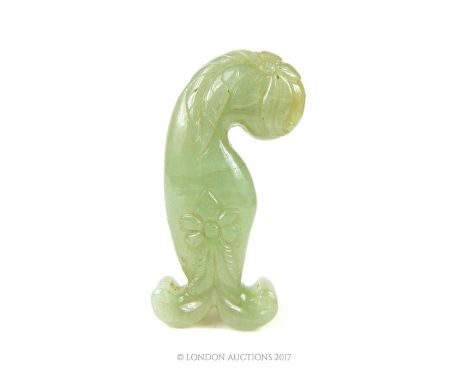 A carved Jade sword hilt, decorated with plain floral motifs; 12.5 cm long.