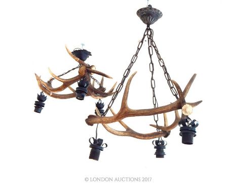Two vintage antler mounted ceiling lights; with each light featuring three interlocked antler stag horns; 54cm wide.