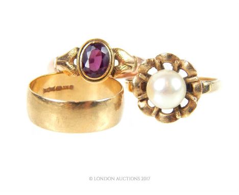 Three 9 ct yellow gold ladies rings consisting of one one pearl and yellow gold flower head ring (Ring Size: M 1/2), one yell