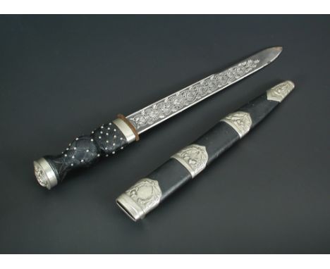 A Scottish Pipers regimental dirk of the Highland Light Infantry, the etched blade signed Henry Wilkinson, carved wood basket