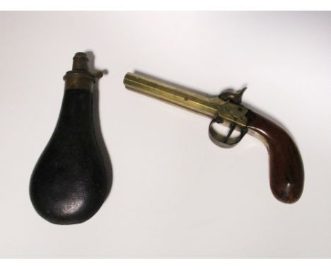 A double barrelled percussion pistol, with Liege stamp and walnut stock, 22cm, together with a leather powder flask (2)  